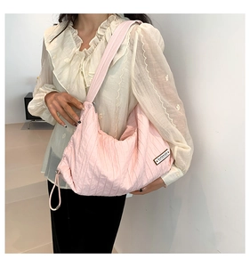 Detail showing pink pleated canvas bag fabric with a SUPERIOR brand tag on the side