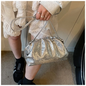 Detail showing metallic silver snake skin texture and pleated design of the cloud bag