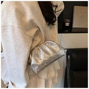 Detail of silver embossed leather cloud bag with pleated texture and thin shoulder strap