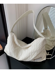 Large off-white pleated canvas tote bag with a minimalist shoulder strap and zip closure