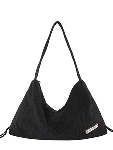 Large black pleated canvas tote bag with superior label and long shoulder strap