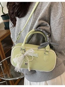 Avocado green bowling bag with silk ribbon handle and lace butterfly charm