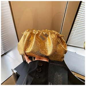 Detailed view of golden pouch bag with snakeskin texture and pleated design details