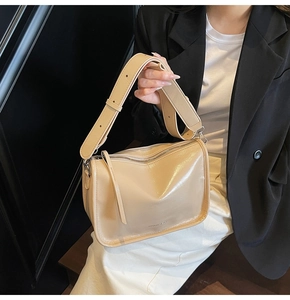 Détail du sac bandoulière brillant crème avec large sangle réglable et fermeture éclair