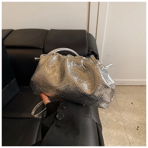 Detail of silver metallic dumpling bag with snake skin texture and pleated handle
