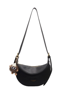 Classic black leather dumpling bag with golden hardware and cute monster pendant