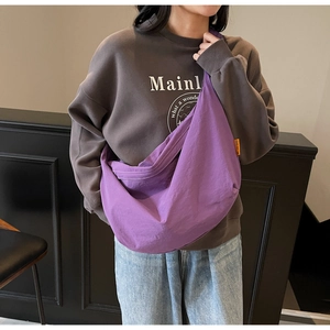 Detailed view of the large purple crescent tote bag showing spacious capacity and nylon texture