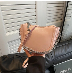 Pink glossy saddle bag with silver chain strap and adjustable leather shoulder handle