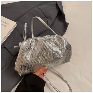 Close-up of silver snake-patterned drawstring bag with metallic finish and knot detail