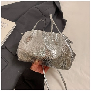 Close-up of silver textured cloud bag featuring embossed snakeskin pattern and soft pleats