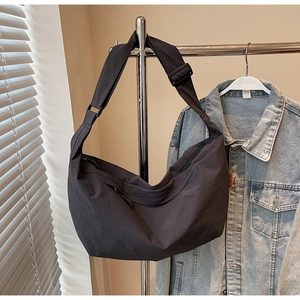 Detail of dark grey nylon crescent bag showing large capacity and adjustable wide strap