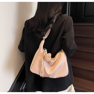 Pale pink crescent bag in soft leather with adjustable strap and bear charm