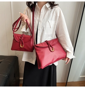 Size comparison of burgundy leather shoulder bags with woven detail and gold U-buckle