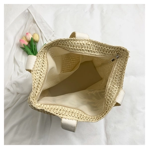 Top view of the spacious inner compartment of the woven beach bag with zipper and lining