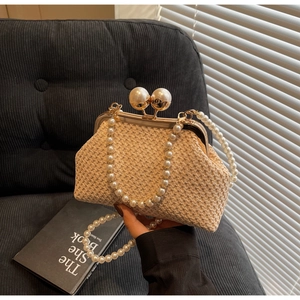 Detailed straw woven bag featuring large pearl clasps and refined bead strap accents