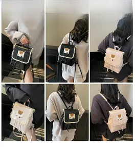 Detail view of cute school backpack with lace edges and brown bear patch for women
