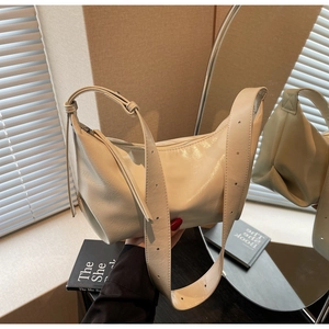 Macro detail of cream white textured PU leather shoulder bag with adjustable strap