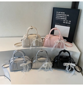 Close-up of stylish handbags in five colors with lace bows and pearl charms details