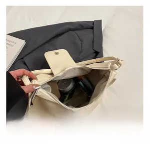 Detailed interior of cream tote bag showing large capacity and zipper closure