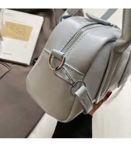 Detail of light blue glossy patent leather handbag with premium silver metal zipper hardware