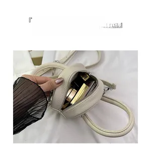 Detail showing the large capacity and organized compartments of the white mini leather bag