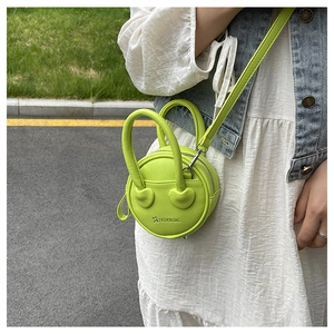 Detailed view of lime green micro round bag with heart smile face and pebbled texture