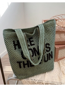 Sage green woven beach tote with embroidered 'HERE COMES THE SUN' lettering design