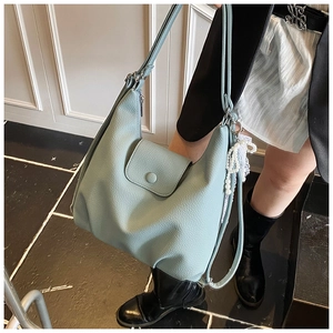 Detail of light blue lychee pattern faux leather tote bag with lace and pearl charm