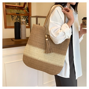 Detail of handwoven tote bag with brown stripes and decorative wooden bead tassels