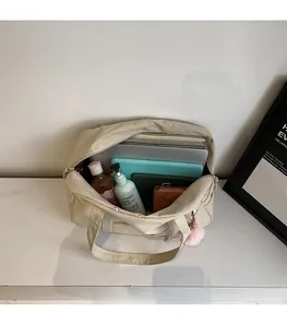 Interior view of large beige canvas tote bag showing spacious capacity for laptop and gear