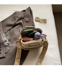 Detail shot of spacious interior for cream bucket bag holding phone, wallet and umbrella