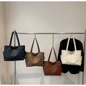 Collection of minimalist solid color tote bags in black, taupe, brown, and cream white