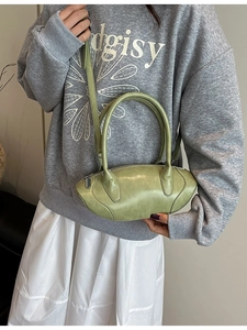 Chic avocado green oval handbag with dual handles and detachable shoulder strap in soft leather