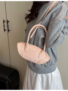 Chic light pink curved shoulder bag with rounded handles for stylish women's commuting