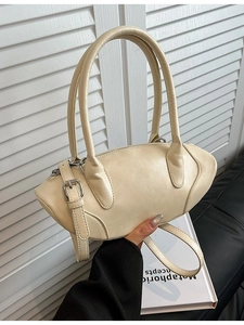 Chic beige leather shoulder bag with sleek rugby silhouette and thin handles