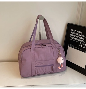 Large capacity purple canvas travel bag with side pockets and a cute plush charm accessory
