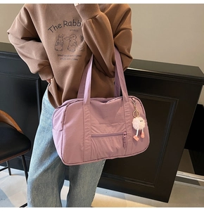 Detail of lavender large capacity tote bag with front zipper and plush mascot charm