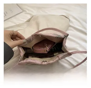 Detail view of the spacious pink embroidered bucket bag showing interior storage capacity
