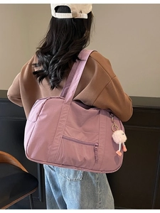 Lavender purple large capacity canvas travel tote bag shown on model in a minimalist setting