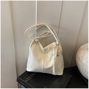 Détail du sac seau blanc en simili cuir plissé avec breloques perles et dentelle rétro
