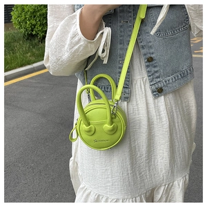Fluorescent green mini round bag with heart-shaped handle detail and fashion logo