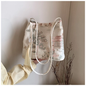 Detailed view of traditional Chinese embroidery and silk tassel on the bucket bag