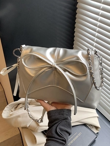 Chic silver shoulder bag with large bow and metal chain strap for stylish women