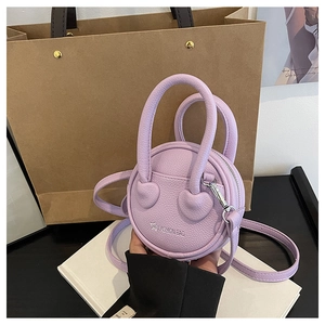 Detail of a purple round mini bag with heart decor and removable shoulder strap