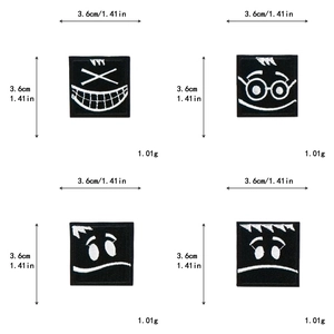 Detail showing four black square patches with cute white embroidered facial expressions