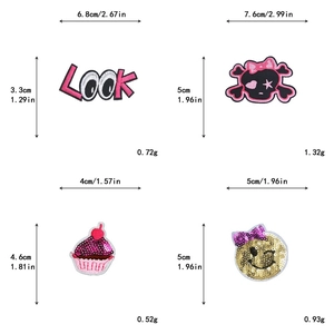 Detailed view of pink embroidery patches featuring LOVE, skull, cupcake and wink face