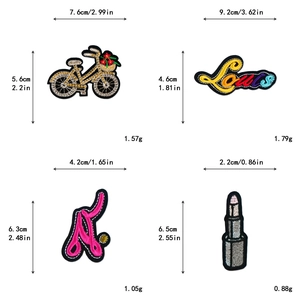 Macro detail of four embroidered patches including bicycle and lipstick for DIY clothing