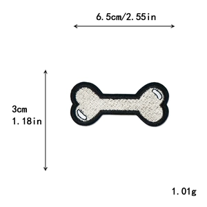 White bone-shaped embroidery patch with black edges and dimensions 6.5cm by 3cm