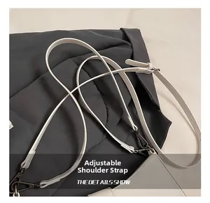 Detail of adjustable beige leather strap with gunmetal buckle for shoulder bags