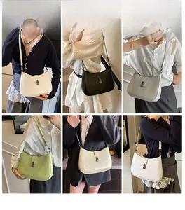 Detail view of stylish half-moon crossbody bag with metal buckle in various colors